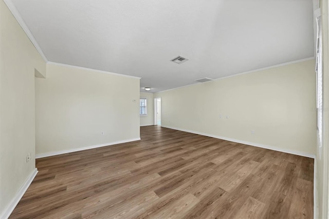 unfurnished room with hardwood / wood-style flooring and ornamental molding