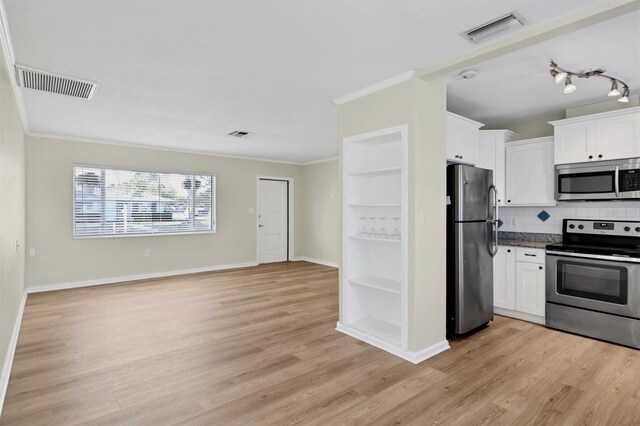 kitchen with white cabinets, light wood-type flooring, and stainless steel appliances