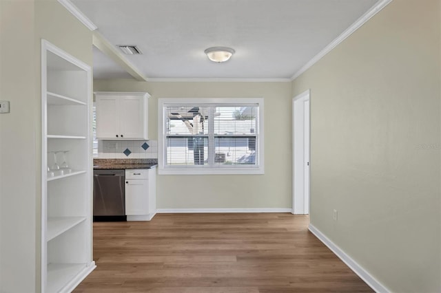 interior space featuring dishwasher, light hardwood / wood-style flooring, decorative backsplash, white cabinets, and ornamental molding