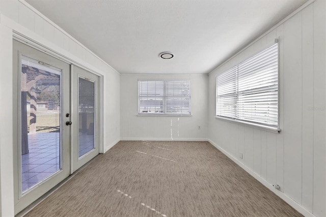 spare room with crown molding, french doors, and carpet floors