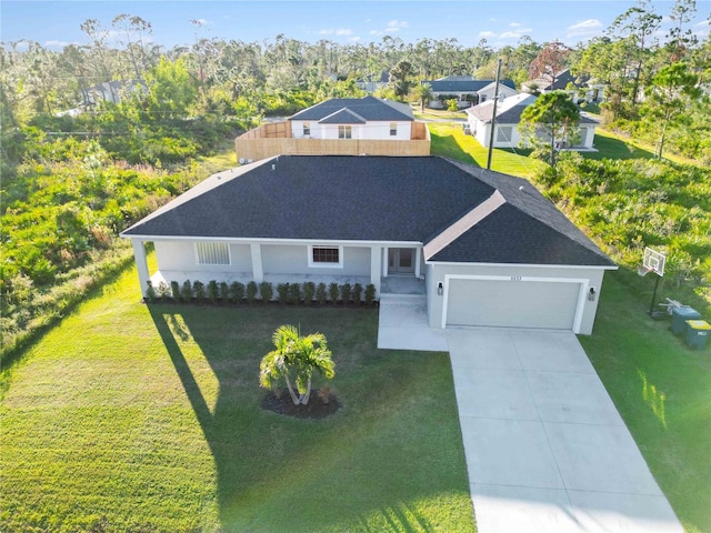 view of front of house with a garage and a front yard