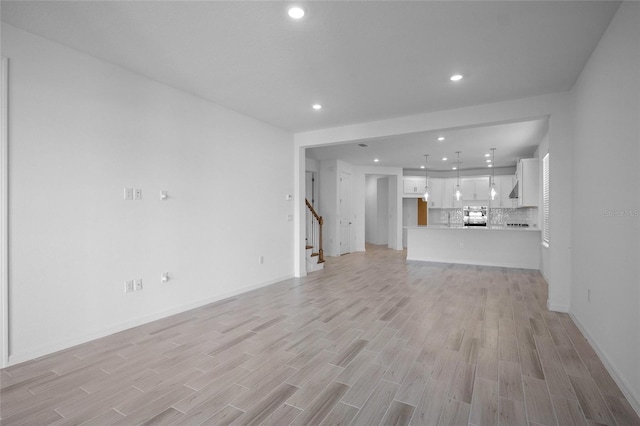 unfurnished living room with light wood-type flooring