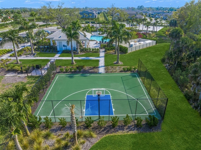 view of basketball court with a yard