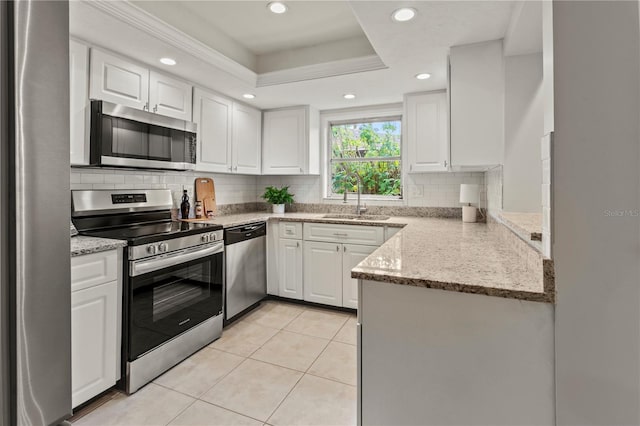 kitchen featuring light stone counters, sink, white cabinets, and appliances with stainless steel finishes