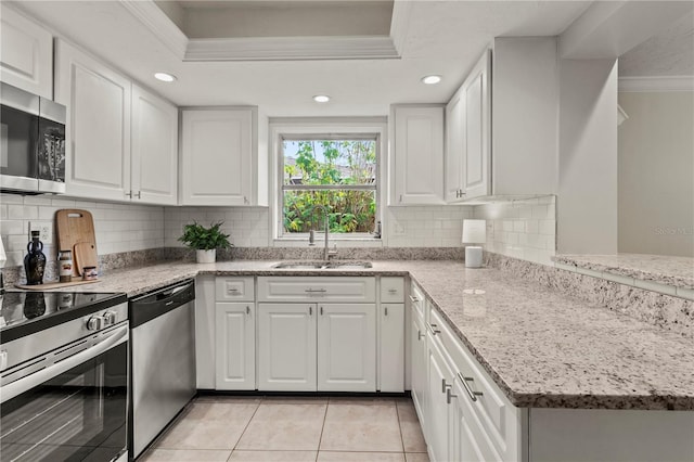 kitchen with crown molding, sink, white cabinets, and appliances with stainless steel finishes