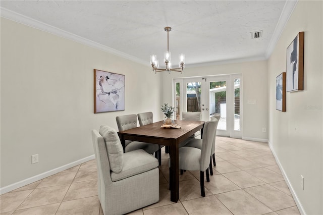 dining space featuring french doors, a notable chandelier, ornamental molding, and light tile patterned flooring