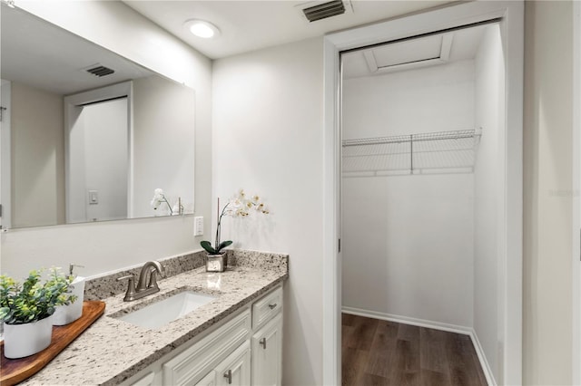 bathroom with vanity and hardwood / wood-style flooring