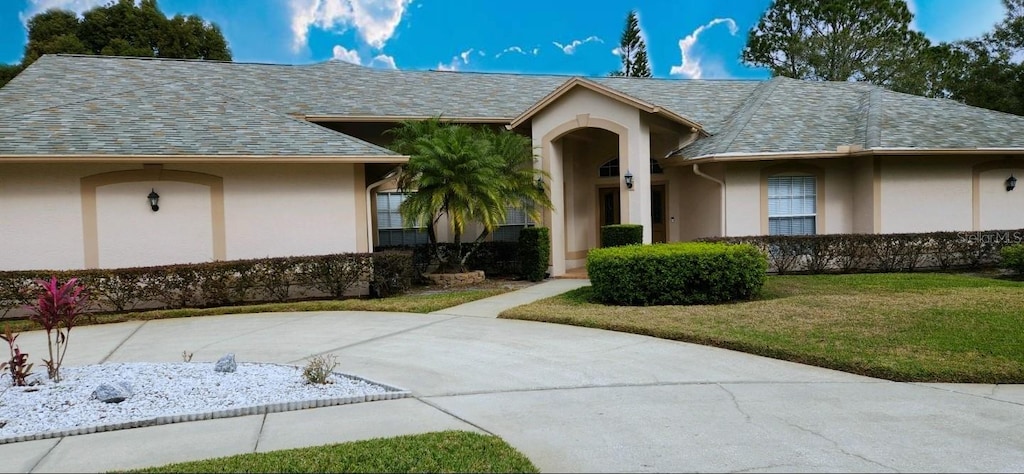 doorway to property with a lawn