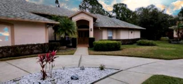 ranch-style home featuring a front yard