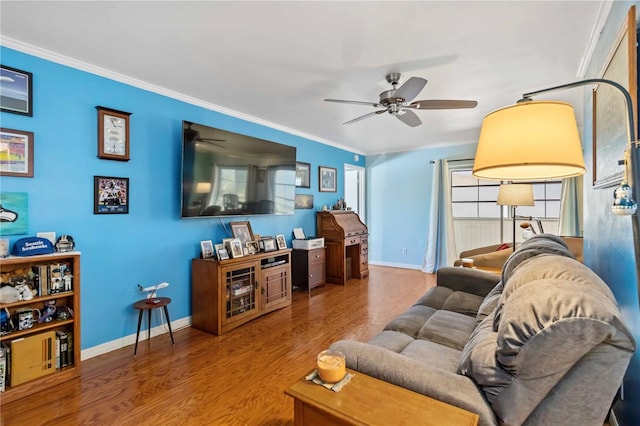 living room featuring ceiling fan, wood-type flooring, and ornamental molding