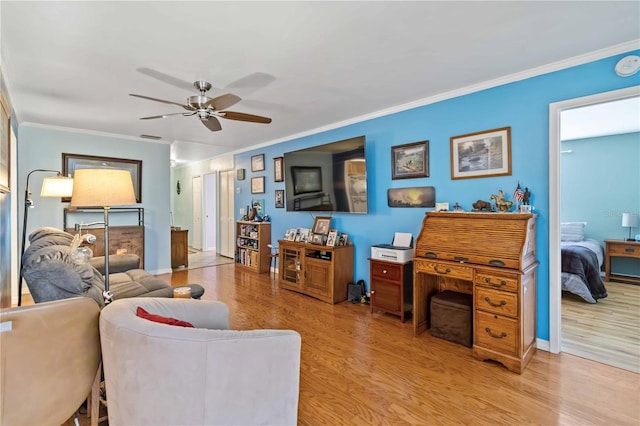 living room with crown molding, ceiling fan, and light hardwood / wood-style floors