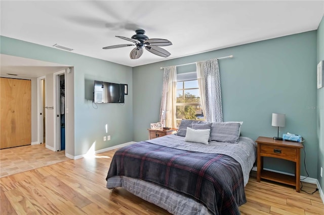 bedroom with light hardwood / wood-style floors and ceiling fan