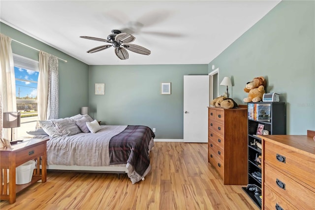 bedroom with light hardwood / wood-style flooring and ceiling fan