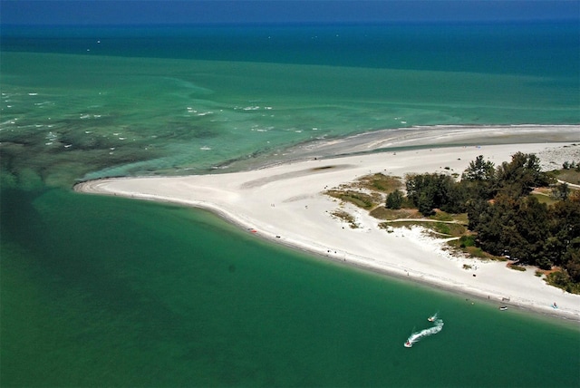 aerial view with a water view and a beach view