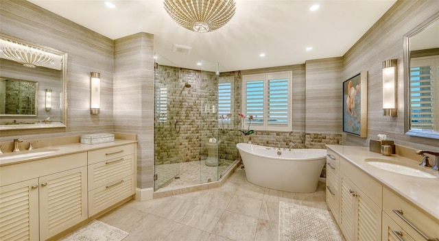 bathroom featuring a healthy amount of sunlight, vanity, tile walls, and independent shower and bath