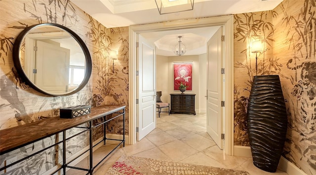 corridor with light tile patterned floors and an inviting chandelier