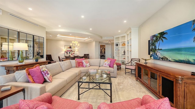 living room with a raised ceiling and an inviting chandelier