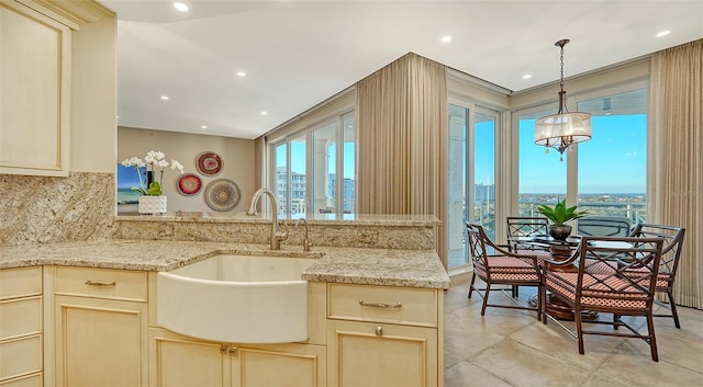 kitchen featuring decorative light fixtures, tasteful backsplash, a wealth of natural light, and sink