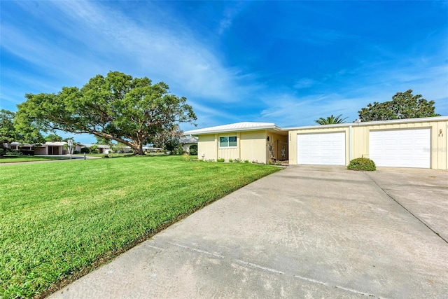 ranch-style home featuring a garage and a front yard