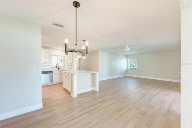 kitchen with white cabinetry, dishwasher, ceiling fan, sink, and light hardwood / wood-style floors