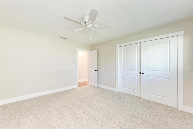 unfurnished bedroom with ceiling fan, a closet, and carpet floors