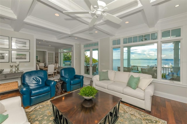 sunroom / solarium featuring beamed ceiling, a water view, and coffered ceiling