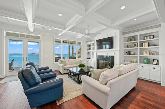 living room featuring french doors, a water view, dark hardwood / wood-style floors, a wealth of natural light, and beamed ceiling