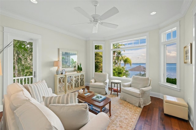 sunroom featuring a water view and ceiling fan