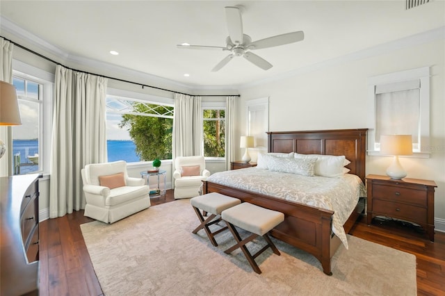 bedroom with ceiling fan, crown molding, a water view, and dark wood-type flooring