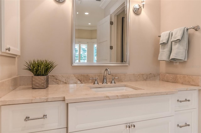 bathroom featuring vanity and crown molding