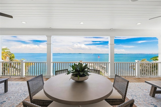 sunroom / solarium featuring a water view and plenty of natural light