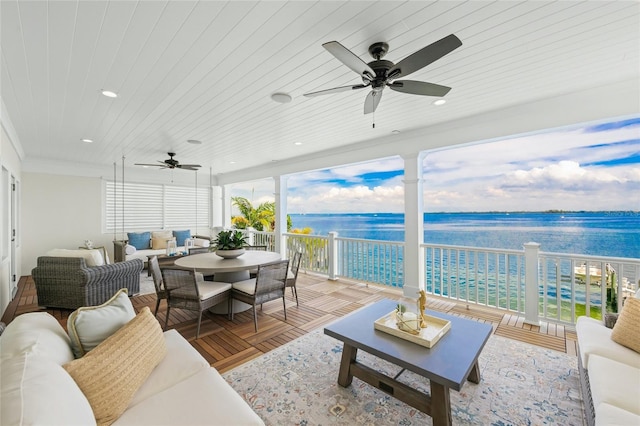 sunroom / solarium with ceiling fan, a water view, and wood ceiling