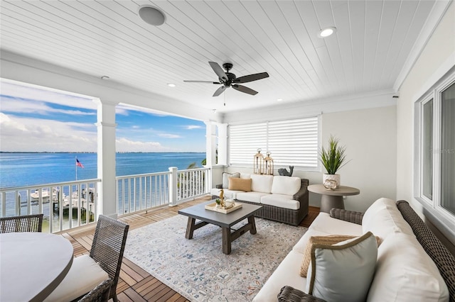 sunroom / solarium featuring a water view, ceiling fan, and wood ceiling