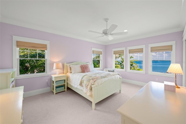 bedroom with multiple windows, ceiling fan, light carpet, and ornamental molding