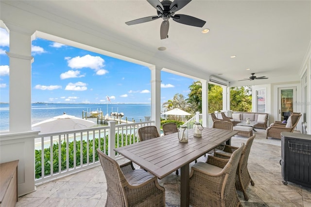 exterior space featuring ceiling fan and a water view