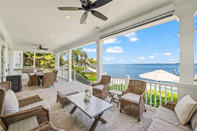 view of patio / terrace with an outdoor living space, a water view, area for grilling, and ceiling fan