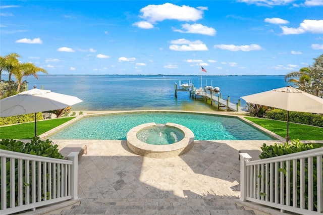 view of pool featuring a lawn, an in ground hot tub, a dock, and a water view