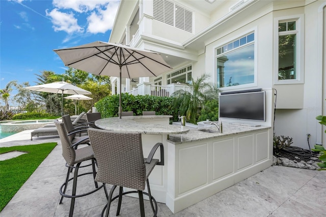 view of patio with an outdoor bar