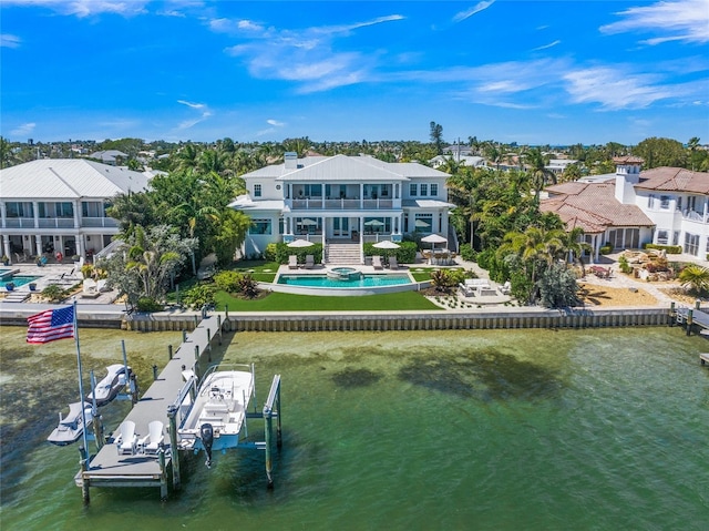 rear view of property with a balcony and a water view