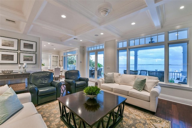 living room featuring hardwood / wood-style flooring, a water view, beamed ceiling, and coffered ceiling