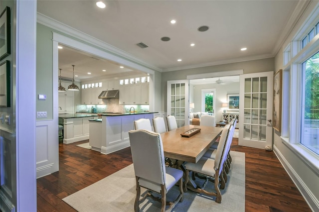 dining room featuring ceiling fan, french doors, sink, dark hardwood / wood-style floors, and ornamental molding