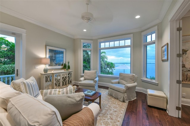 living room with hardwood / wood-style floors, a wealth of natural light, crown molding, and ceiling fan