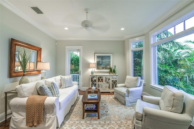 interior space featuring a wealth of natural light, crown molding, ceiling fan, and hardwood / wood-style flooring