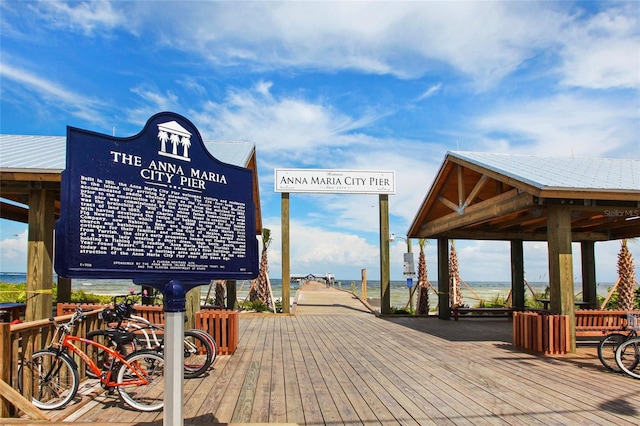 surrounding community featuring a deck with water view