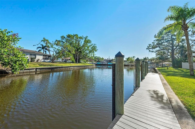 dock area featuring a yard and a water view