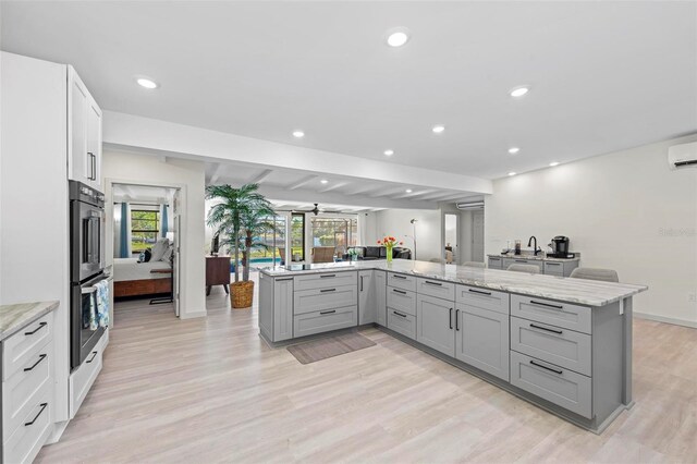 608 69th Ave W, Bradenton, FL 34207 - kitchen featuring gray cabinetry, double oven, healthy amount of natural light, and recessed lighting