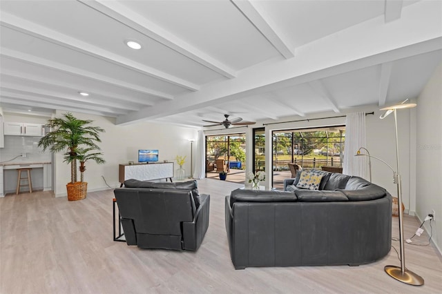 living room featuring beam ceiling, light wood-type flooring, and ceiling fan