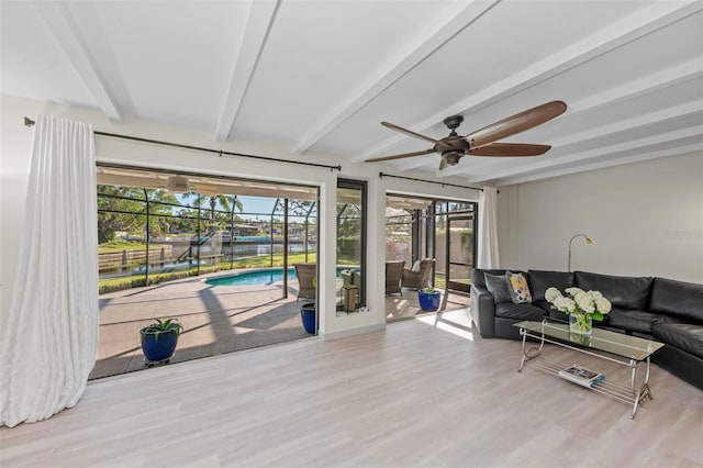 living room featuring ceiling fan, beamed ceiling, and light hardwood / wood-style floors