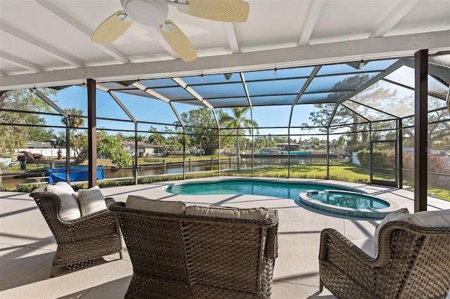 view of pool featuring a patio area, glass enclosure, a water view, and a pool with connected hot tub