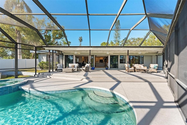 view of pool featuring a patio area, ceiling fan, glass enclosure, and an outdoor hangout area